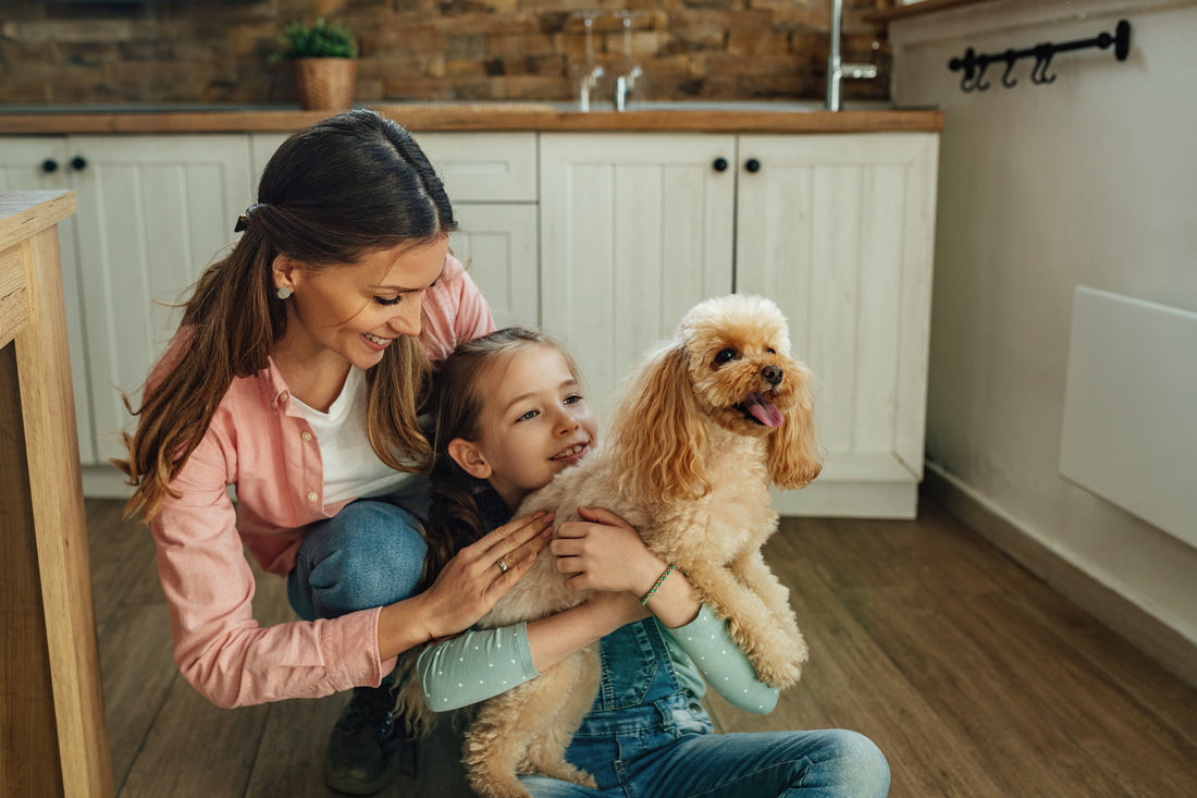mother-daughter-hugging-small-dog