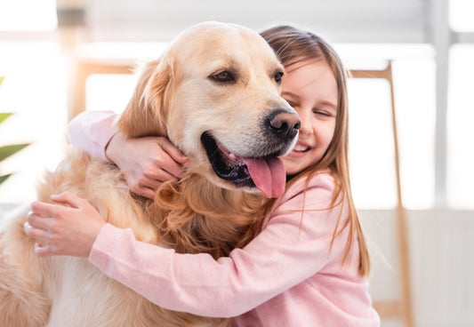 child-hugging-golden-retriever