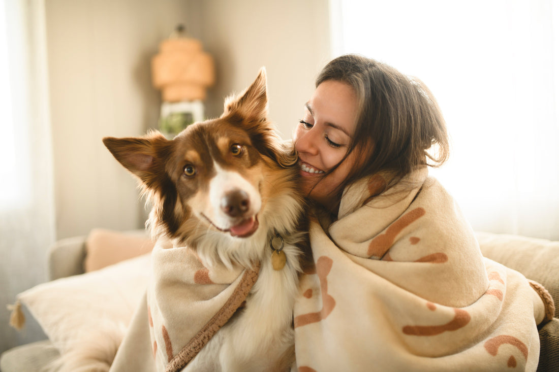 Woman-With-Fluffy-Australian-Shepherd-Under-Blanket