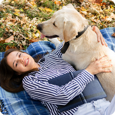 woman-relaxing-with-dog-outdoors